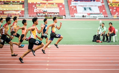 A group of people running on the track

